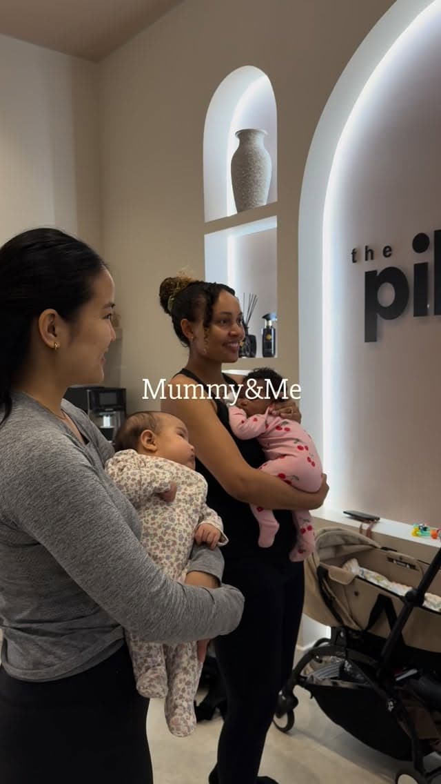 Two mothers with their babies in the studio reception