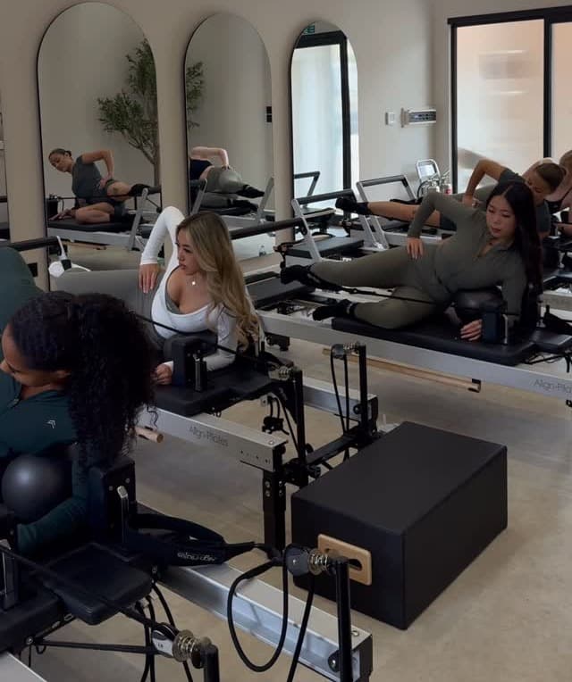 Side-lying reformer series in progress at The Pilates Grounds